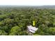 Aerial view of a house nestled in a lush forest setting at 5711 John Anderson Hwy, Flagler Beach, FL 32136