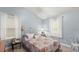 Charming bedroom with floral bedding and ample natural light at 5711 John Anderson Hwy, Flagler Beach, FL 32136