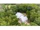 Aerial view of house nestled in a wooded area at 5711 John Anderson Hwy, Flagler Beach, FL 32136