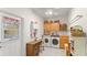 Bright laundry room with washer, dryer, and ample storage at 5711 John Anderson Hwy, Flagler Beach, FL 32136