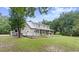 View of the home's back, highlighting the deck and screened porch at 5711 John Anderson Hwy, Flagler Beach, FL 32136