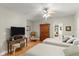 Spacious bedroom with twin beds, hardwood floors, and a large TV at 5711 John Anderson Hwy, Flagler Beach, FL 32136