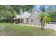House exterior with a wraparound porch and landscaping at 5711 John Anderson Hwy, Flagler Beach, FL 32136