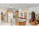 Open kitchen with granite island, stainless steel appliances, and access to Gathering room at 5711 John Anderson Hwy, Flagler Beach, FL 32136