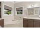 Elegant bathroom with corner bathtub, double vanity, and dark brown cabinets at 5711 John Anderson Hwy, Flagler Beach, FL 32136