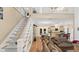 Main living area with open floor plan, stairs, and high ceilings at 5711 John Anderson Hwy, Flagler Beach, FL 32136