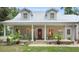 Front porch with rocking chairs and lush landscaping at 5711 John Anderson Hwy, Flagler Beach, FL 32136