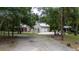 House with a gravel driveway surrounded by trees at 5711 John Anderson Hwy, Flagler Beach, FL 32136