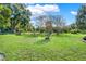 Landscaped backyard with mature trees and a tranquil atmosphere at 6008 Sw 103Rd Loop, Ocala, FL 34476