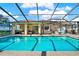 Large screened-in pool with plenty of patio space at 6008 Sw 103Rd Loop, Ocala, FL 34476