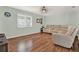 Spacious living room with light walls, laminate floors, and sectional sofa at 6008 Sw 103Rd Loop, Ocala, FL 34476