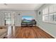 Living room with laminate wood floors and large TV at 6008 Sw 103Rd Loop, Ocala, FL 34476
