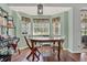 Cozy dining area with wood table and chairs, overlooking backyard at 6008 Sw 103Rd Loop, Ocala, FL 34476
