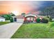 Charming single-story home with a red accent, showcasing curb appeal at 6008 Sw 103Rd Loop, Ocala, FL 34476