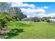 Expansive grassy backyard with a view of the screened pool and patio at 6008 Sw 103Rd Loop, Ocala, FL 34476