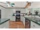 Kitchen features stainless steel appliances and wood-look laminate floors at 6008 Sw 103Rd Loop, Ocala, FL 34476