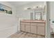 Double vanity bathroom with a bathtub and updated flooring at 6008 Sw 103Rd Loop, Ocala, FL 34476