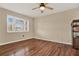 Bright bedroom with wood-look floors and ceiling fan at 6008 Sw 103Rd Loop, Ocala, FL 34476