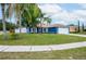 Charming blue house with mature landscaping and a two-car garage at 1171 Daimler Dr, Apopka, FL 32712