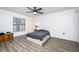 Spacious bedroom with wood-look flooring and large window at 1171 Daimler Dr, Apopka, FL 32712
