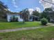 Single story home with palm tree and driveway at 1777 Oasis Ave, Deltona, FL 32725