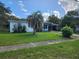 Single story home with palm tree and driveway at 1777 Oasis Ave, Deltona, FL 32725