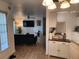 Open living room with dark green sofa and large TV at 1777 Oasis Ave, Deltona, FL 32725