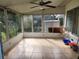 Bright sunroom with tiled floor and backyard access at 1777 Oasis Ave, Deltona, FL 32725