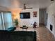 Bright living room featuring a comfy sectional sofa and large TV at 1777 Oasis Ave, Deltona, FL 32725