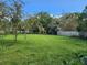 Spacious grassy backyard with mature trees at 1777 Oasis Ave, Deltona, FL 32725
