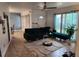 Open living area with a green sectional sofa and access to dining area at 1777 Oasis Ave, Deltona, FL 32725