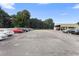 Large paved commercial parking lot with cars parked at 2490 N Woodland Blvd, Deland, FL 32720