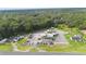 Aerial view of property with multiple buildings and large parking area at 2490 N Woodland Blvd, Deland, FL 32720