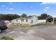 Commercial building with parking and adjacent structure at 2490 N Woodland Blvd, Deland, FL 32720