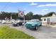 Commercial property with cars in front and signage at 2490 N Woodland Blvd, Deland, FL 32720