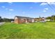 Brick home with a large grassy yard at 2490 N Woodland Blvd, Deland, FL 32720