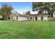 Charming ranch house with a well-manicured lawn at 2730 Woodland Dr, Edgewater, FL 32141