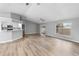 Open living room with vaulted ceiling, laminate flooring, and sliding glass doors to patio at 2730 Woodland Dr, Edgewater, FL 32141