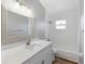 Updated bathroom with white vanity, tub, and tile at 2730 Woodland Dr, Edgewater, FL 32141