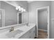 Modern bathroom with dual vanity, quartz countertops, and elegant light fixtures at 2730 Woodland Dr, Edgewater, FL 32141