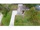 Aerial view of a house with a large backyard and driveway at 2730 Woodland Dr, Edgewater, FL 32141