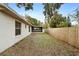 Side yard with screened patio and wooden fence at 2730 Woodland Dr, Edgewater, FL 32141