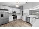 Modern kitchen with white shaker cabinets and stainless steel appliances at 2730 Woodland Dr, Edgewater, FL 32141