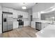 Modern kitchen with white cabinets, stainless steel appliances, and quartz countertops at 2730 Woodland Dr, Edgewater, FL 32141