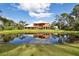 Two story house with screened porch reflected in a pond at 3344 S Ridgewood Ave, Port Orange, FL 32129