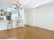 Kitchen with breakfast bar, modern chandelier, and hardwood floors at 4 Oceans West Blvd # 108B, Daytona Beach, FL 32118