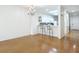 Spacious dining area with hardwood floors and chandelier at 4 Oceans West Blvd # 108B, Daytona Beach, FL 32118