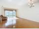 Bright living room with hardwood floors and access to a balcony at 4 Oceans West Blvd # 108B, Daytona Beach, FL 32118