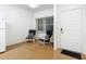 Living area with two armchairs, hardwood floors and exterior door at 4 Oceans West Blvd # 108B, Daytona Beach, FL 32118