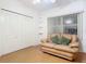 Secondary bedroom with hardwood floors and built-in shelving at 4 Oceans West Blvd # 108B, Daytona Beach, FL 32118